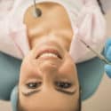young lady in dental chair looking up
